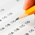 Photo of a hand with a pencil on a test sheet. 