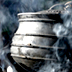 Photo of an iron pot on a smoking fire