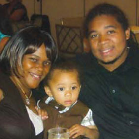 This photo shows a young African American couple with a toddler. 