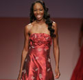 Tennis player Venus Williams walks the runway in a red dress
