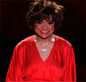 Actress Eartha Kitt wears a long red dress at the 2006 Olympus Fashion Week 2006