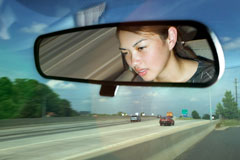 girl driving car, rearview mirror