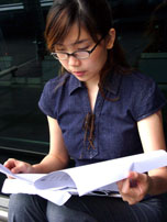 Teen girl looking at papers