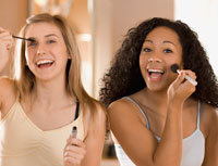 teen girls applying makeup