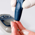 Photo of a person administering a blood glucose test