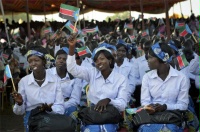 Date: 07/09/2012 Description: Women wave South Sudanese flags as they attend the country's anniversary celebrations, at the John Garang mausoleum in Juba, South Sudan, Monday, July 9, 2012. The world's newest nation, South Sudan, is celebrating its first birthday. © AP Image