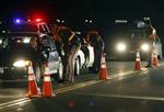 Jefferson County Sheriff Department officers ask drivers if they have been drinking while smelling for alcohol at a mobile Driving Under the Influence (DUI) checkpoint in Golden, Colorado late April 12, 2008. REUTERS/Rick Wilking