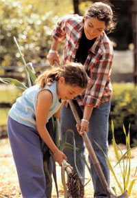 Woman and child working in a garden.