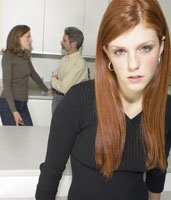 teen with parents arguing in the background
