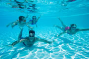 A family swimming underwater.