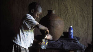 Image of a girl pouring water into a glass from a clay pot