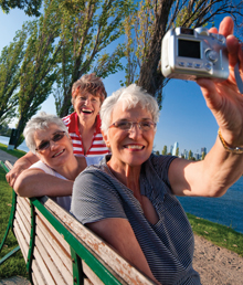 three older women taking a photo.