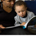 photo of a woman reading a story to a young boy.
