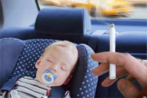 a baby inhaling secondhand smoke