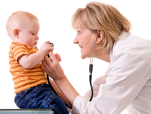 Photo of doctor examining toddler.