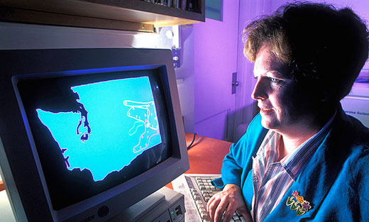 Agricultural Research Service soil microbiologist Ann Kennedy checks a computer map that shows the location of various biological groupings across the Columbia Plateau in Washington State.