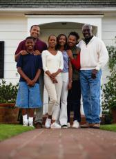 Photograph of a family in front of their house