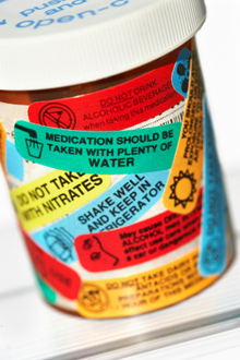 Photo of a pill bottle with many warning labels.