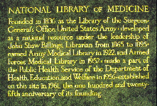 Gilded text carved in granite inside entrance of NLM, describing in brief the history of the NLM.