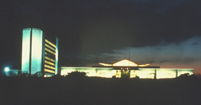 National Library of Medicine complex (Buildings 38 and 38A), looking west from Rockville Pike, illuminated at nighttime.