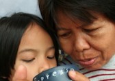 Grandmother and grandchild looking into a cup