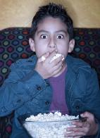 Boy having popcorn.