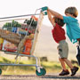 Photo: Two boys pushing shopping cart