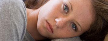 Photo: Depressed girl lying down
