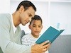 Father reading son a book