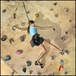 child climbing rock wall