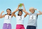 Three kids holding a trophy