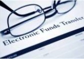 Glasses on Page Saying Electronic Funds Transfer