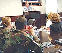 Author Richard Bausch speaking to troops at the Fort Drum workshop, June 6, 2004