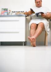 Photograph of a male patient waiting in an exam room