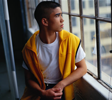 Young man looking out of a window