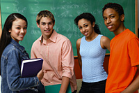 4 students in front of chalkboard