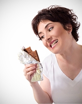 A woman stares down a chocolate bar