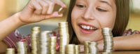 Image shows a girl making stacks of coins.