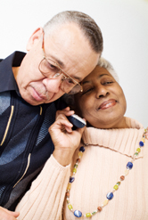 A senior wife and husband on the phone.