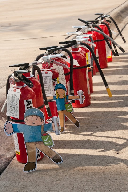 Flat Stanley and Flat Stella with fire extinguishers.