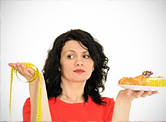 A woman holding measuring tape and desserts