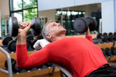 A man lifts weights at the gym.