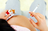 A pregnant woman smokes.