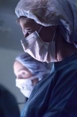 Photograph of two female surgeons preparing for surgery