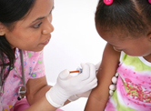 A young child gets a vaccine.