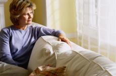 Photograph of a woman sitting on a couch