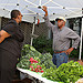 May Newsletter 12 - An OPM employee talks to one of the venders about his fresh produce