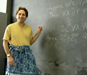 Image of Scott Aaronson wearing a sarong while proving a theorem in his class.