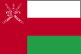 Flag of Oman is three horizontal bands of white, red, and green of equal width with a broad, vertical, red band on hoist side; the national emblem in white is centered near top of vertical band. 2004.