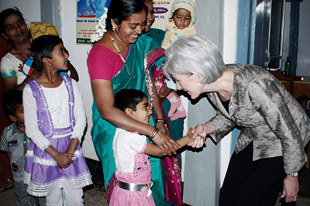 HHS Secretary Sebelius greeting a child in Belgaum, India.
